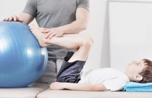 Young Boy Doing Physical Therapy Exercise